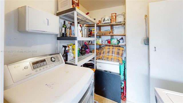 laundry room with washing machine and clothes dryer and laundry area