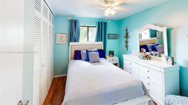 bedroom with a closet, ceiling fan, wood finished floors, and baseboards