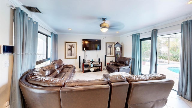 living room with crown molding, light tile patterned flooring, and visible vents