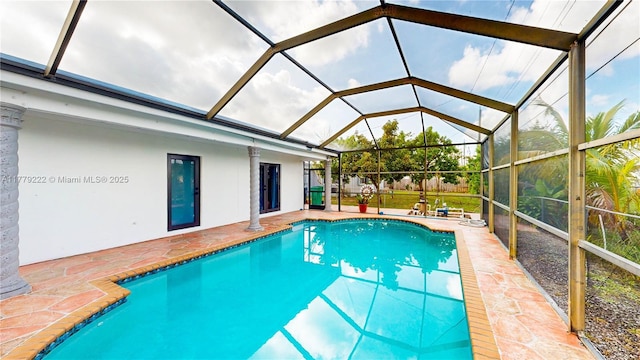 outdoor pool featuring a patio area and a lanai