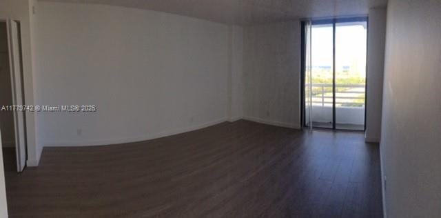 unfurnished room featuring dark wood-style flooring