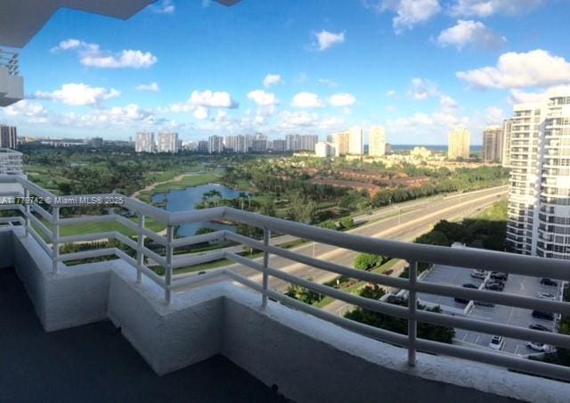 balcony featuring a water view and a view of city