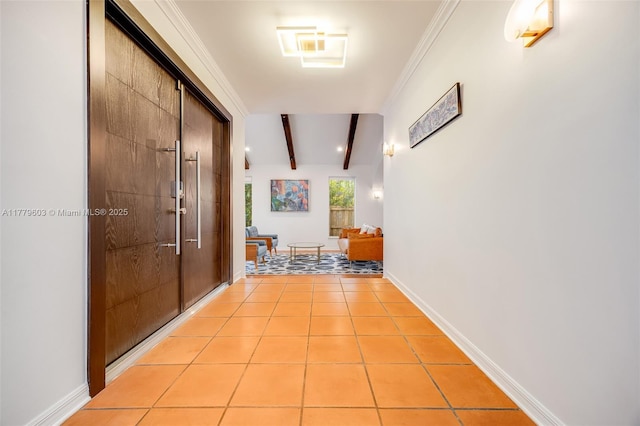 corridor featuring beamed ceiling, baseboards, and light tile patterned floors