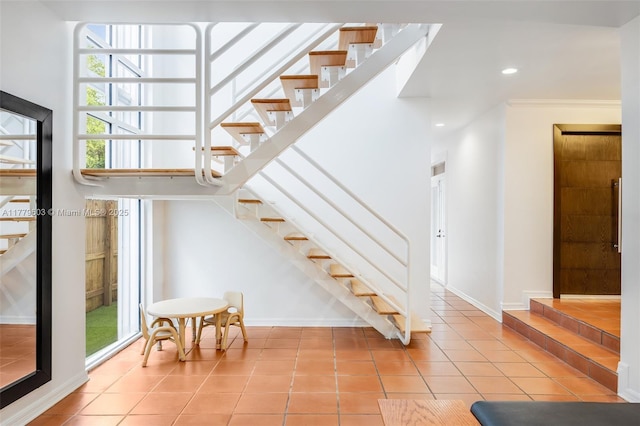 stairs with recessed lighting, tile patterned flooring, baseboards, and crown molding