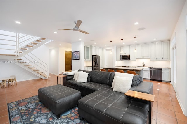living area with light tile patterned floors, recessed lighting, and stairway