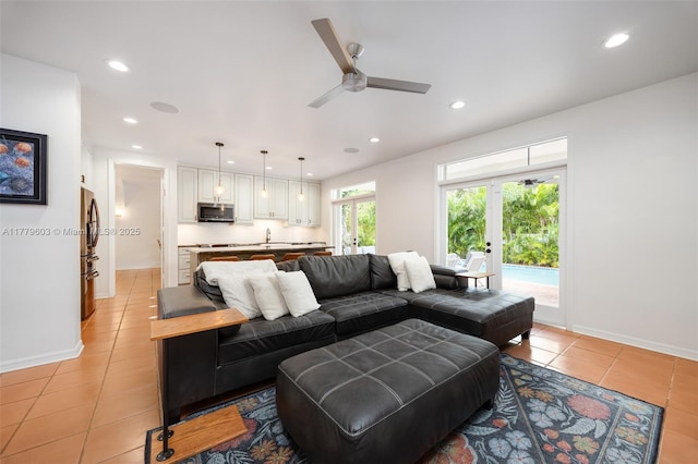 living room with light tile patterned floors, baseboards, a ceiling fan, and recessed lighting
