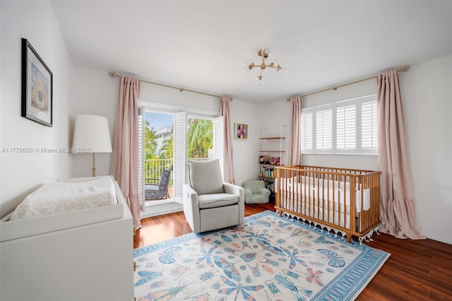 bedroom with wood finished floors and multiple windows