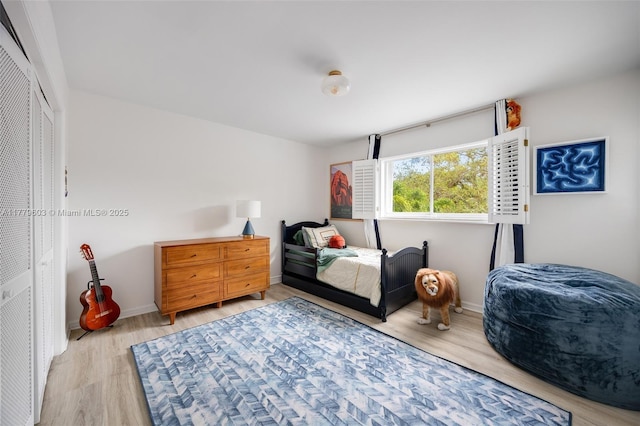 bedroom featuring light wood-style flooring and baseboards