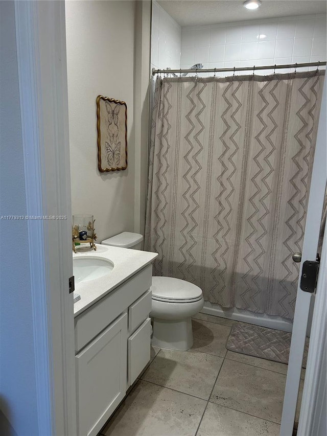 full bathroom with vanity, toilet, and a shower stall