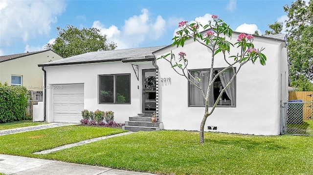 2019 SW 17th Ter, Miami, FL 33145 - view of front of home featuring a garage, stucco siding, and driveway