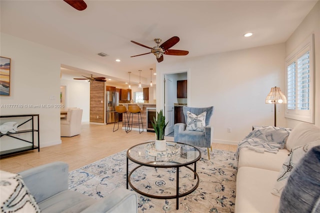 living area with recessed lighting, a ceiling fan, visible vents, and a wealth of natural light