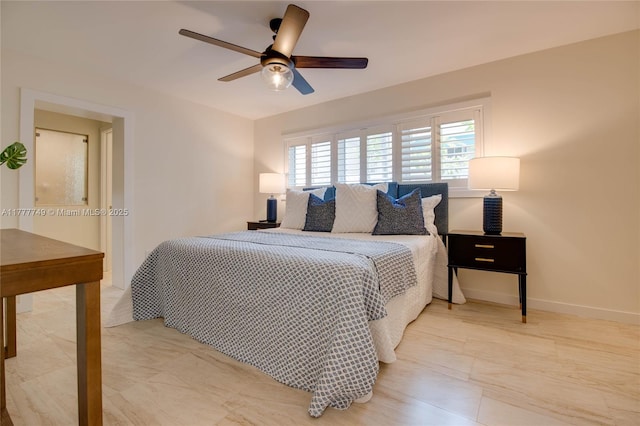 bedroom with a ceiling fan and baseboards