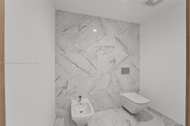 1135 103rd St Unit 402, Bay Harbor Islands, FL 33154 - bathroom with marble finish floors, toilet, and a bidet