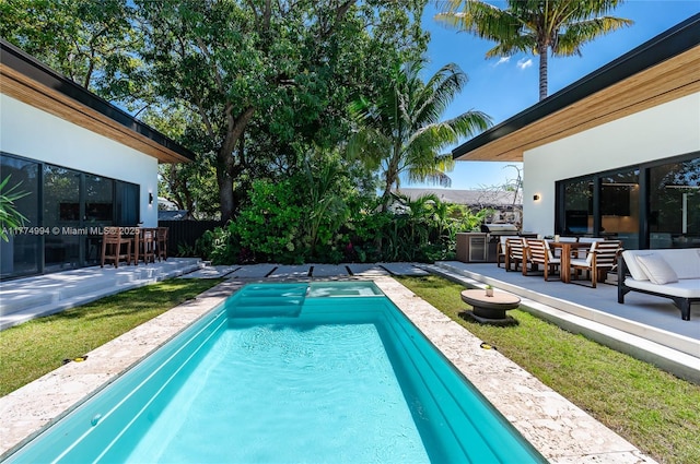 pool with outdoor dining space, fence, and a patio