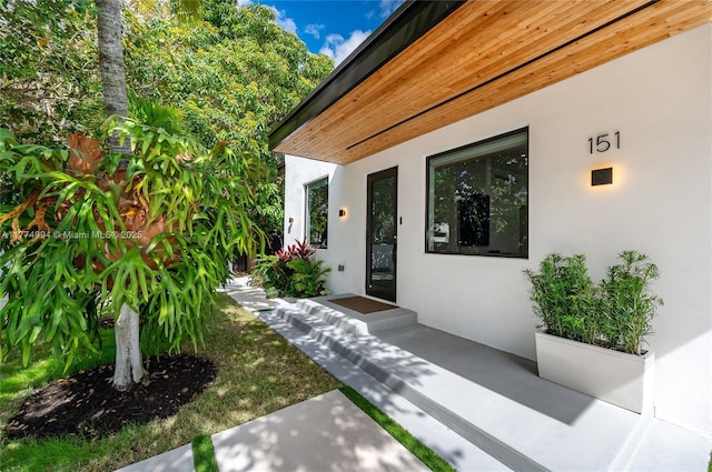 doorway to property with stucco siding