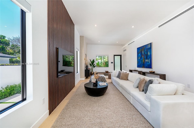 living area featuring light wood-style floors and recessed lighting