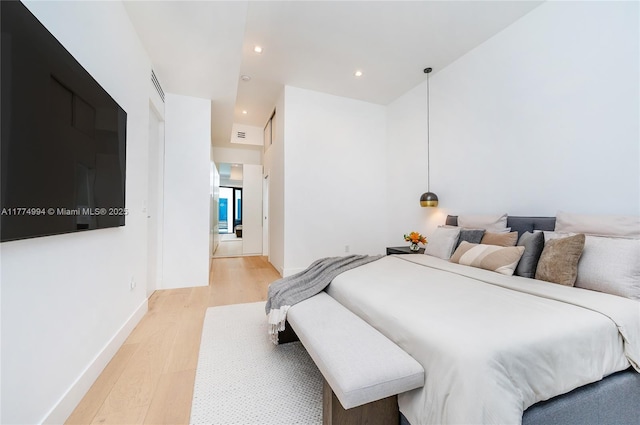 bedroom featuring recessed lighting, light wood finished floors, and baseboards