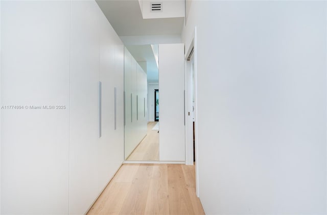 hall with visible vents and light wood-type flooring