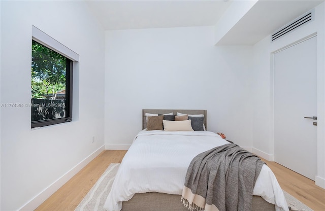 bedroom featuring wood finished floors and baseboards