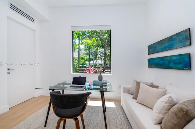 office area featuring wood finished floors, baseboards, and visible vents