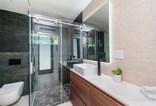 bathroom with toilet, a stall shower, and vanity