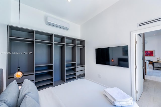 bedroom featuring a wall mounted AC and visible vents