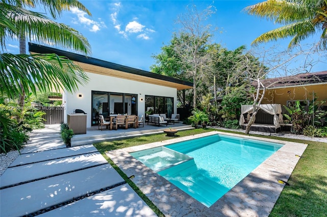view of pool with an outdoor living space, a patio, a pool with connected hot tub, and fence
