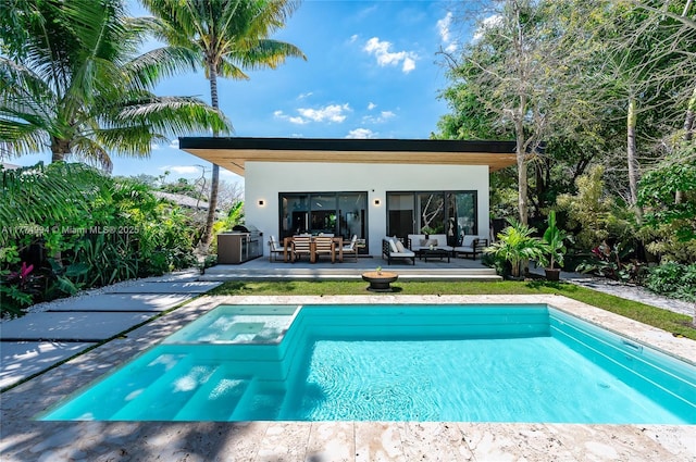 view of pool with a patio area, an outdoor living space, and a pool with connected hot tub