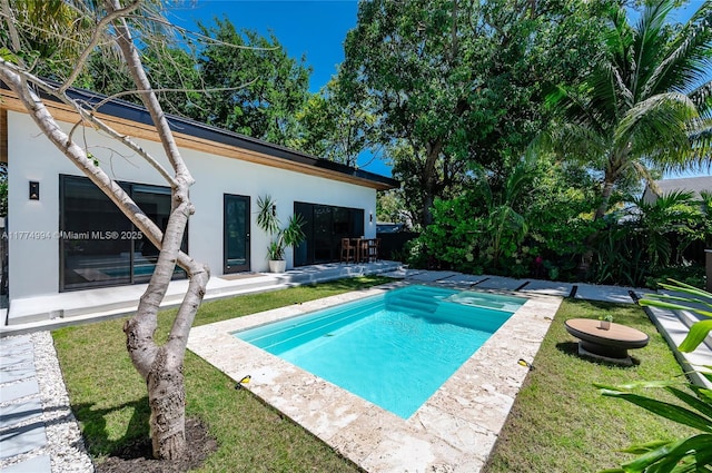 view of pool with a yard and a patio area