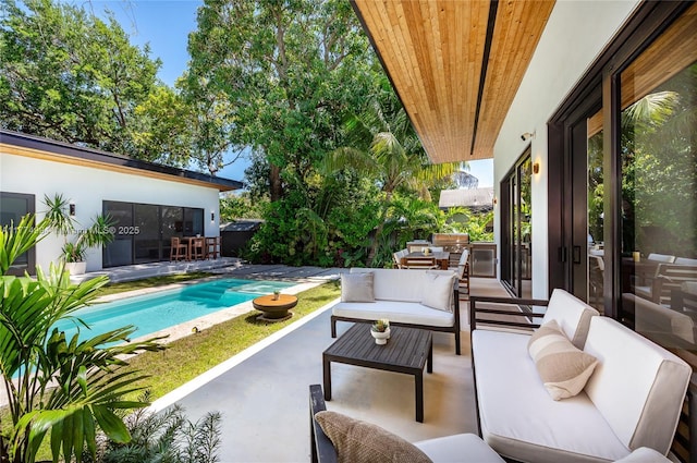 view of patio featuring outdoor lounge area and an outdoor pool