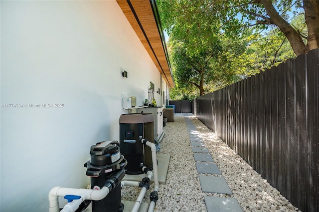 view of home's exterior with a fenced backyard, stucco siding, and central AC unit