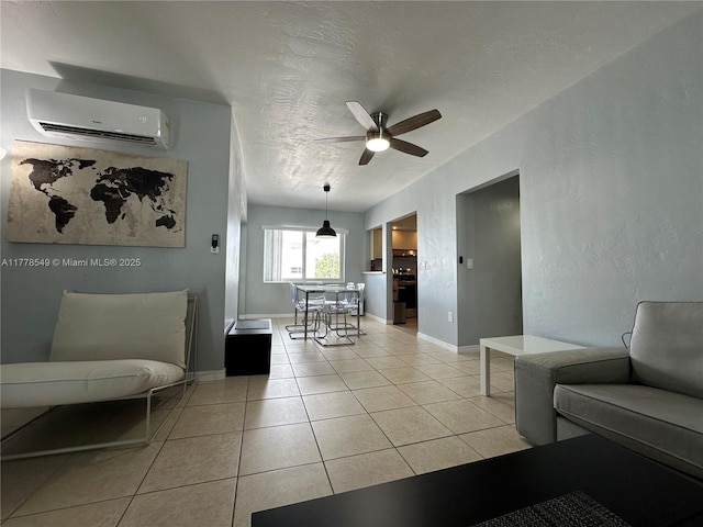 801 Atlantic Shores Blvd Unit 203, Hallandale Beach, FL 33009 - living area featuring a wall unit AC, a ceiling fan, light tile patterned floors, baseboards, and a textured ceiling