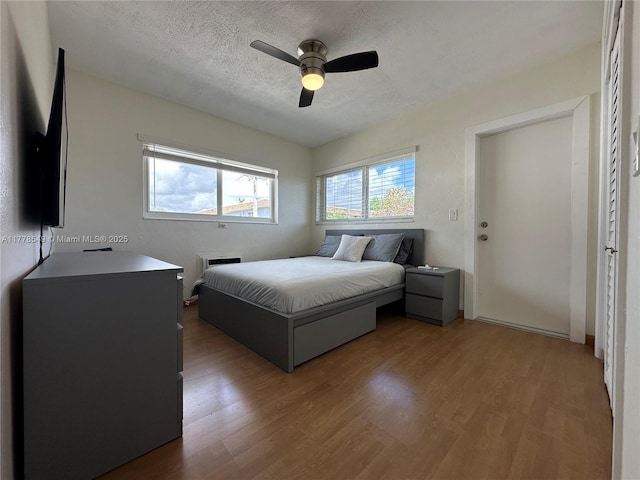 801 Atlantic Shores Blvd Unit 203, Hallandale Beach, FL 33009 - bedroom with wood finished floors, a textured ceiling, and a ceiling fan