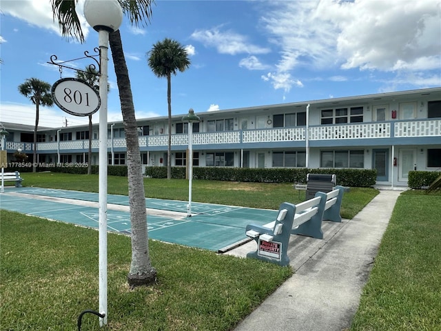 801 Atlantic Shores Blvd Unit 203, Hallandale Beach, FL 33009 - surrounding community with a lawn and shuffleboard