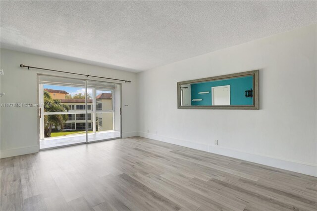 4200 Crystal Lake Dr Unit 303, Deerfield Beach, FL 33064 - unfurnished room with a textured ceiling, wood finished floors, and baseboards