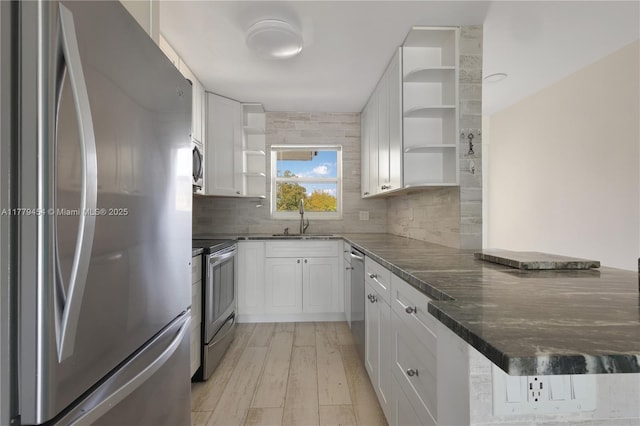 4200 Crystal Lake Dr Unit 303, Deerfield Beach, FL 33064 - kitchen featuring white cabinets, open shelves, a sink, a peninsula, and stainless steel appliances