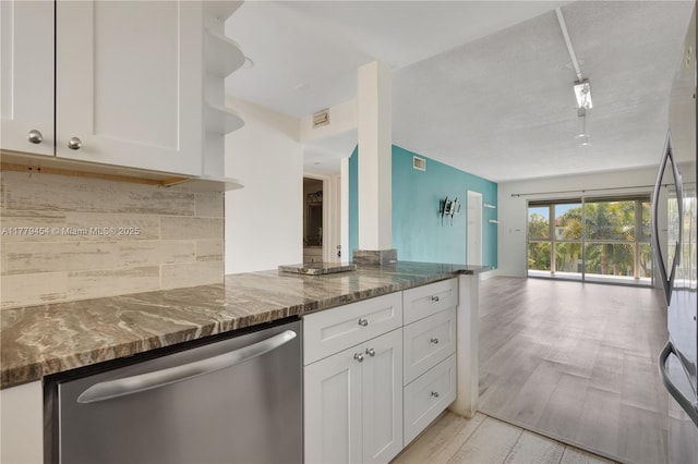 4200 Crystal Lake Dr Unit 303, Deerfield Beach, FL 33064 - kitchen featuring tasteful backsplash, dark stone countertops, open floor plan, white cabinets, and stainless steel appliances