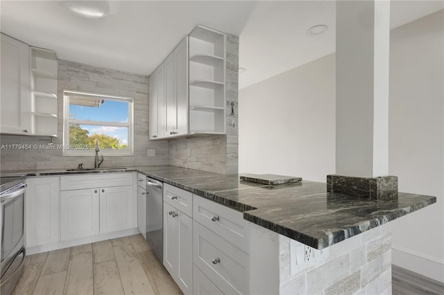 4200 Crystal Lake Dr Unit 303, Deerfield Beach, FL 33064 - kitchen with a peninsula, backsplash, open shelves, stainless steel appliances, and a sink