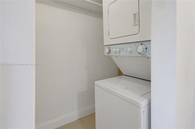 4200 Crystal Lake Dr Unit 303, Deerfield Beach, FL 33064 - clothes washing area with laundry area, stacked washer and dryer, and baseboards