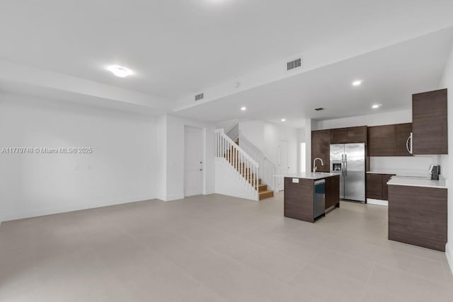 34441 SW 189th Ct, Homestead, FL 33034 - kitchen with stainless steel appliances, dark brown cabinets, light countertops, a center island with sink, and modern cabinets