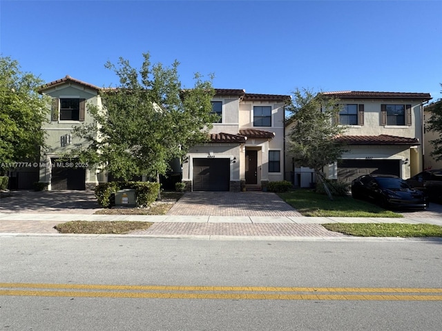 4849 NW 57th Ct, Tamarac, FL 33319 - view of front of house with stucco siding, a tiled roof, decorative driveway, and an attached garage