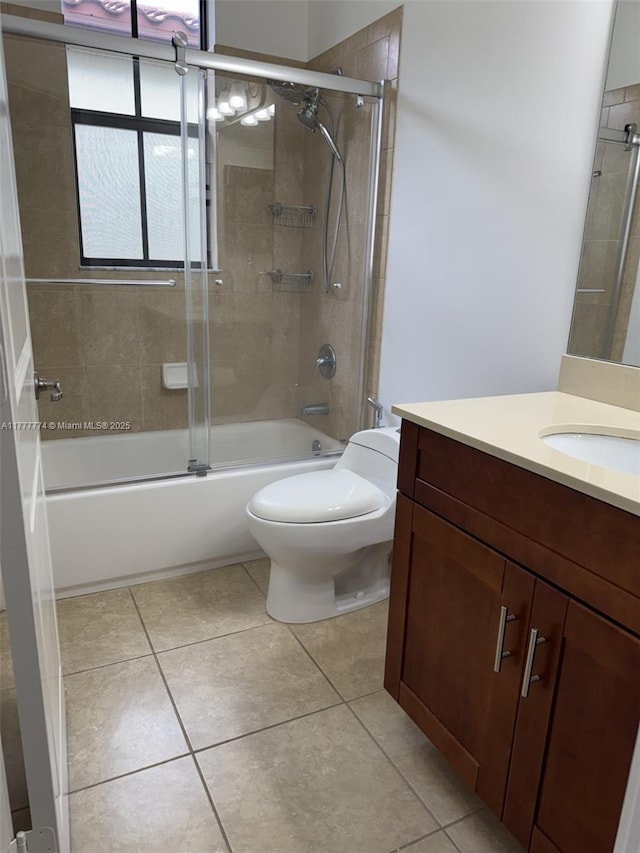 4849 NW 57th Ct, Tamarac, FL 33319 - full bath with toilet, tile patterned floors, vanity, and bath / shower combo with glass door
