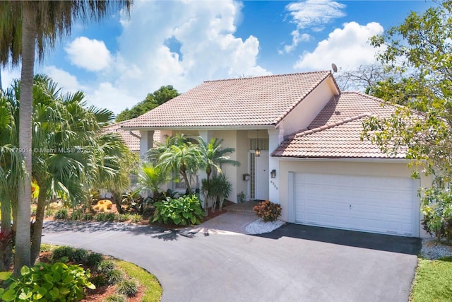 8350 SW 138th Ter, Palmetto Bay, FL 33158 - mediterranean / spanish-style home featuring an attached garage, driveway, stucco siding, and a tile roof