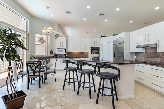 8350 SW 138th Ter, Palmetto Bay, FL 33158 - kitchen with appliances with stainless steel finishes, modern cabinets, visible vents, and under cabinet range hood