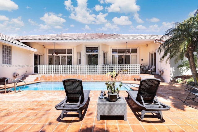 8350 SW 138th Ter, Palmetto Bay, FL 33158 - exterior space featuring stucco siding, an outdoor pool, a ceiling fan, a patio area, and a tile roof