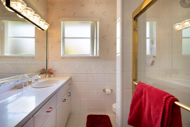 8350 SW 138th Ter, Palmetto Bay, FL 33158 - bathroom with vanity, toilet, wainscoting, tile walls, and wallpapered walls