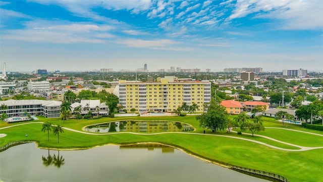 drone / aerial view featuring a water view, golf course view, and a city view