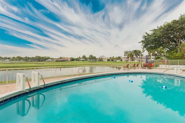 view of swimming pool featuring fence and a fenced in pool