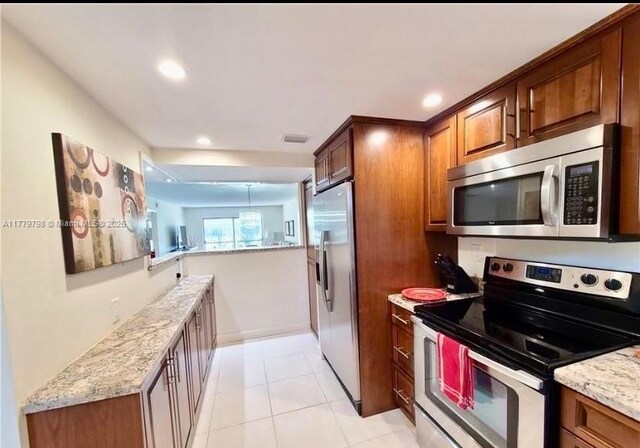6200 NW 44th St Unit 204, Lauderhill, FL 33319 - kitchen with brown cabinetry, visible vents, appliances with stainless steel finishes, light stone counters, and recessed lighting