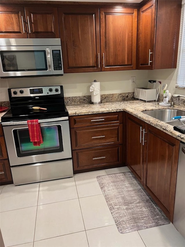 6200 NW 44th St Unit 204, Lauderhill, FL 33319 - kitchen featuring stainless steel appliances, light tile patterned floors, a sink, and light stone counters
